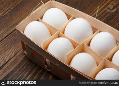 Eggs in a wooden tray on table