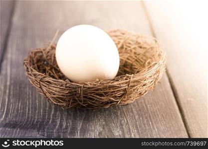 Eggs in nest on old wooden table
