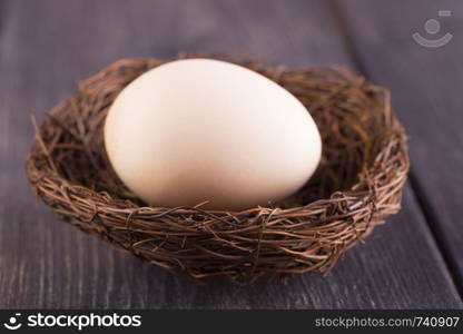 Eggs in nest on old wooden table