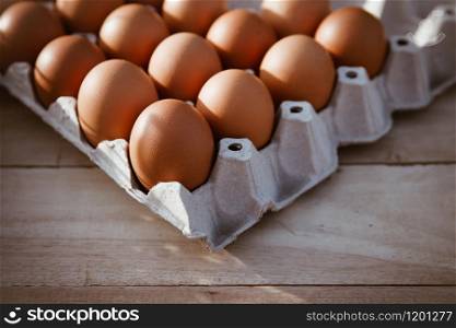 Eggs in paper boxes placed on wooden floors