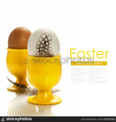 eggs in yellow eggcups isolated on white