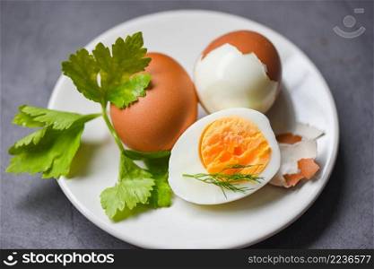 Eggs menu food boiled eggs in a white plate decorated with leaves green dill and parsley, cut in half egg yolks for cooking healthy eating eggs breakfast