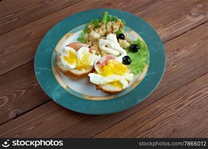Eggs Neptune. layered breakfast dish consisting of English muffin, poached eggs, and hollandaise sauce