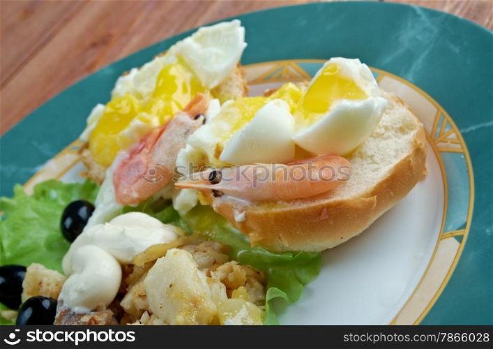 Eggs Neptune. layered breakfast dish consisting of English muffin, poached eggs, and hollandaise sauce