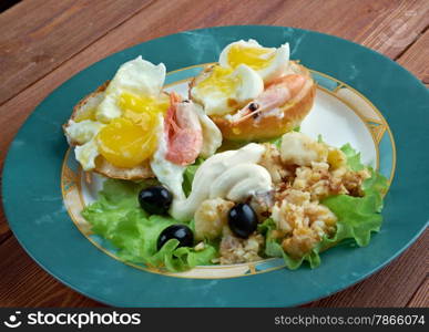 Eggs Neptune. layered breakfast dish consisting of English muffin, poached eggs, and hollandaise sauce