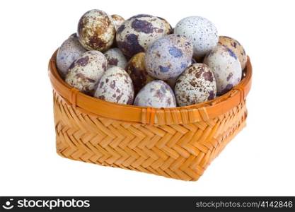 Eggs of quail in basket on white background