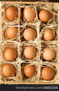 Eggs on straw placed on a wooden table