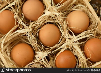 Eggs on straw placed on a wooden table