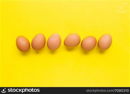Eggs on yellow background. Top view