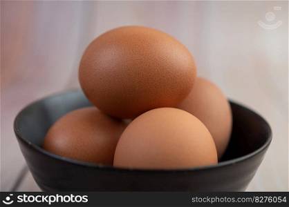 Eggs placed in a cup on a wooden floor. Selective focus.