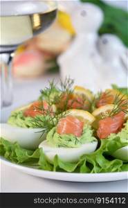 Eggs stuffed with avocado, salmon and lemon. Easter eggs. The perfect appetizer for your holiday table.
