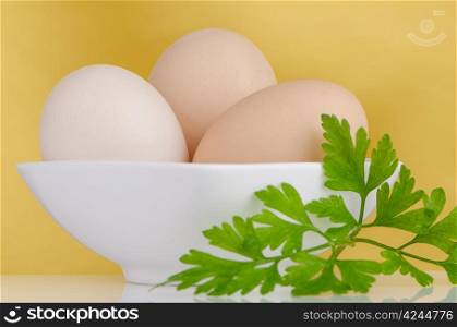 Eggs,Three eggs in the bowl on a yellow background.
