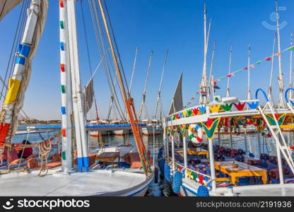 Egiptian touristic boats moored on riverbank of Nile, Luxor. Egiptian touristic boats