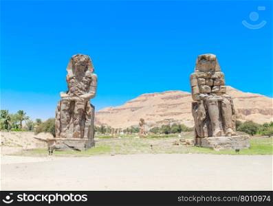 Egypt. Luxor. The Colossi of Memnon - two massive stone statues of Pharaoh Amenhotep III&#xA;&#xA;