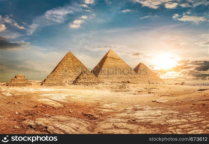 Egyptian pyramids in sand desert and sky