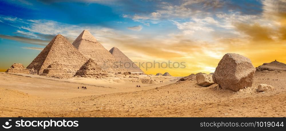 Egyptian pyramids in the desert at sunset