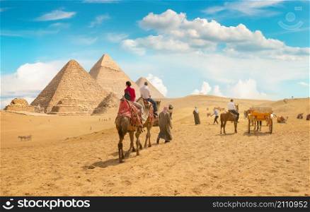 Egyptian pyramids in the desert at sunset
