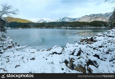 Eibsee lake winter view with thin layer of ice on water surface, Bavaria, Germany.