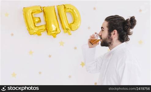 eid al fitr concept with man drinking tea