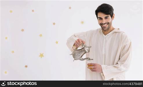 eid al fitr concept with man making tea