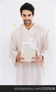 eid al fitr concept with muslim man holding present boxes