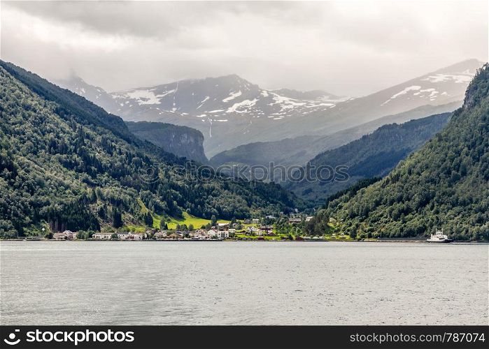 Eidsdal norwegian village at the Tafjord with mountains in the background, Norddal Municipality, More og Romsdal county, Norway.