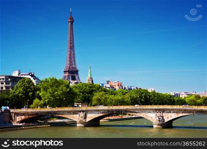 Eiffel Tower and bridge on Seine river in Paris, France. View from Alexandre Bridge at sunny day