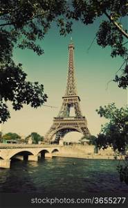 Eiffel Tower and bridge on Seine river in Paris, France. Vintage retro style