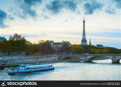 Eiffel Tower and cruise boat on Sienne river. Paris, france