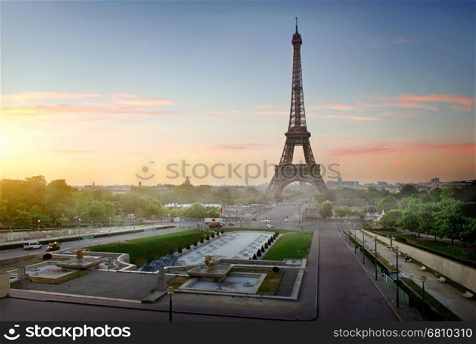 Eiffel Tower and fountains near it at dawn in Paris, France