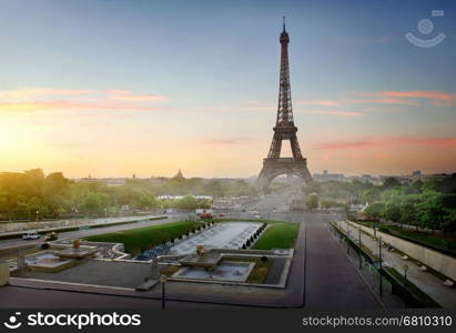 Eiffel Tower and fountains near it at dawn in Paris, France