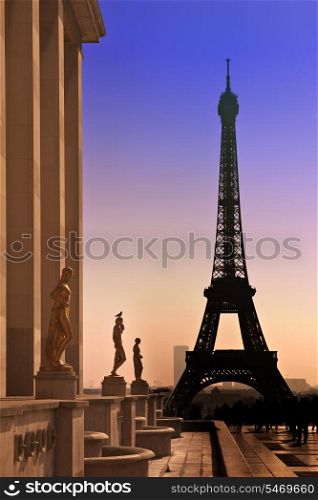 Eiffel Tower and silhouettes of sculptures. View from the Trocadero