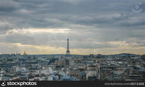 Eiffel tower at horizon in France. Small Eiffel Tower at horizon in France with sprawling urban landscape in foreground