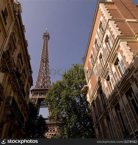 Eiffel Tower behind buildings