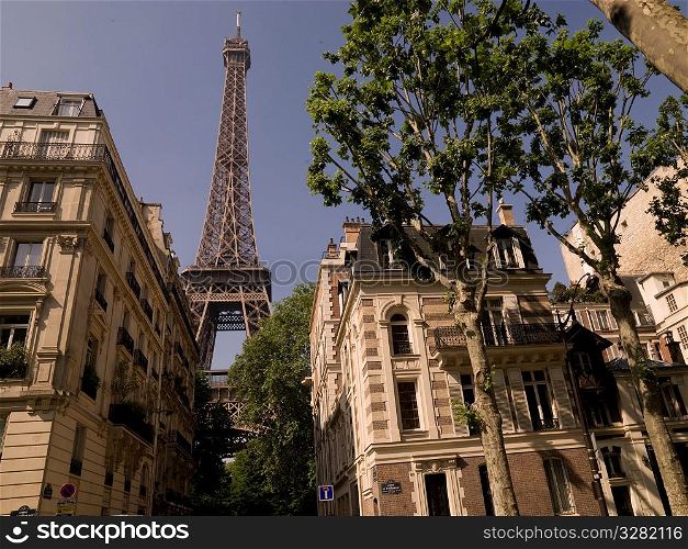 Eiffel Tower behind buildings
