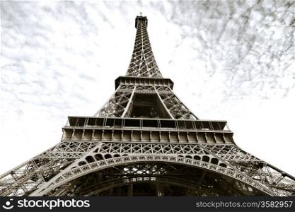 Eiffel tower in Paris with grey clouds bottom view