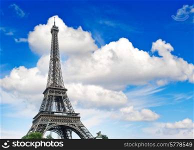 Eiffel Tower (La Tour Eiffel) against cloudy blue sky. Champ de Mars, place of interest in Paris, Europe