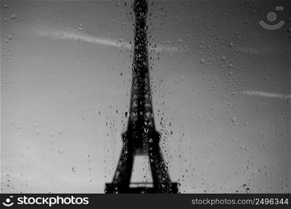 Eiffel Tower through window at rainy day