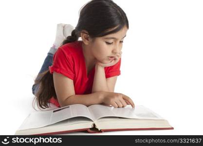 Eight year old girl reading a book o