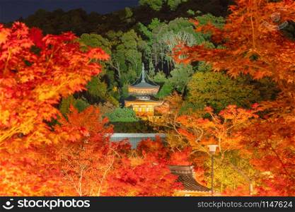 Eikando Zenrinji Temple and wooden bridge with red maple leaves or fall foliage in autumn season. Colorful trees, Kyoto, Japan. Nature landscape background.