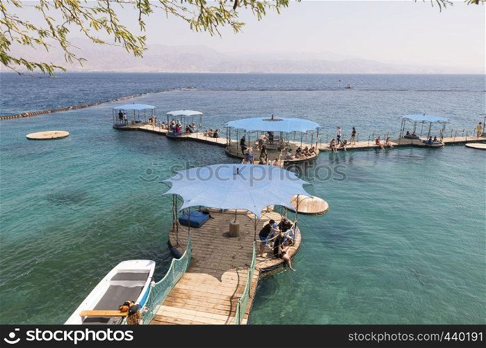 Eilat,Israel,21-march-2019:people enjoy the beach near Eilat, the place where dolphins come freely to the coast and people can watch them. people at the beach of eilat
