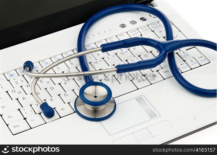 Ein Stethoskop liegt auf der Tastatur eines Computers. Verrechnung und Organisation bei Arzten.