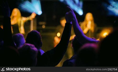 Eindhoven,netherlands,26-jan-2019 loving couple with hands strangled en up having fun while listening to the music on stage during a concert,this is a annual concert with different artists. concert with people hands up