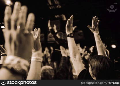 Eindhoven,netherlands,26-jan-2019:people with hands up having fun while listening to the music on stage during a concert,this is a annual concert with different artists in vintage style. concert with people hands up vintage style