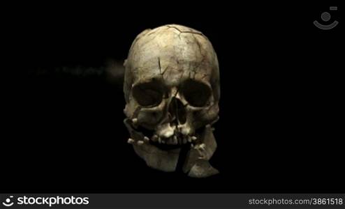 Eine Kugel sprengt einen SchSdelknochen in tausend Teile bei schwarzen Hintergrund