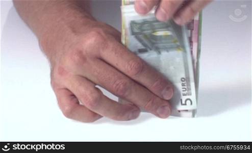 Eine Mann hSlt Euro-Geldscheine in den HSnden und zShlt sie.