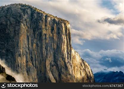 El Capitan rock close-up in Yosemite National Park Valley at cloudy autumn morning from Tunnel View. Low clouds lay in the valley. California, USA.