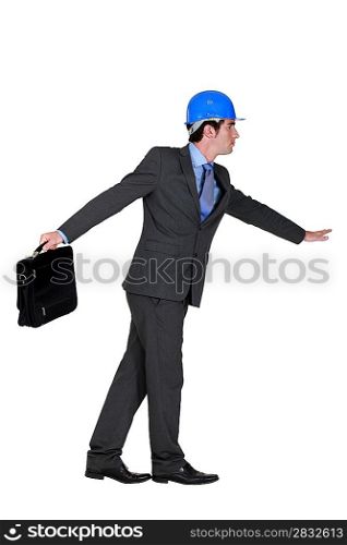 elated foreman in suit holding briefcase against white background