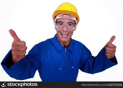 Elated tradesman giving two thumb&acute;s up