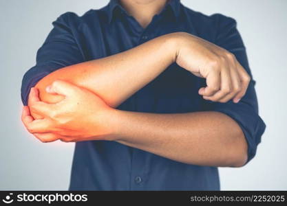 Elbow injury from tennis and golf. The man holds his arm. Pain symptom area is shown with red color. Healthcare knowledge. Medium close up shot.